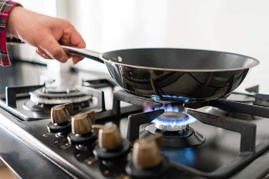 Is it normal to smell gas when turning on an oven