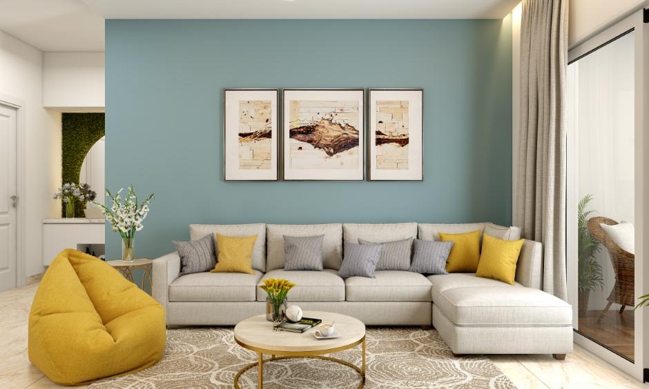 A bright, minimalist living room with neutral tones, a soft beige sofa, textured throw blankets, and a few carefully chosen decor pieces that add warmth and personality.
