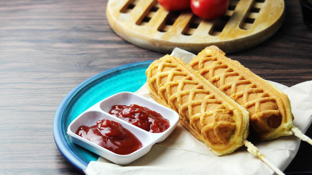 Delicious waffle hotdog on a stick topped with creative ingredients, showcasing unique ways to elevate the classic waffle hotdog treat