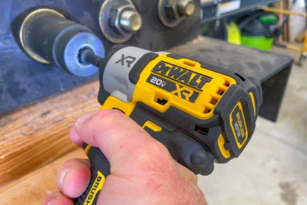 DeWalt 20V MAX XR impact driver with bright LED lights illuminating the workpiece