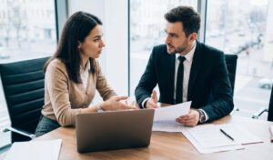 Injured driver discussing a car accident claim with a lawyer in an office